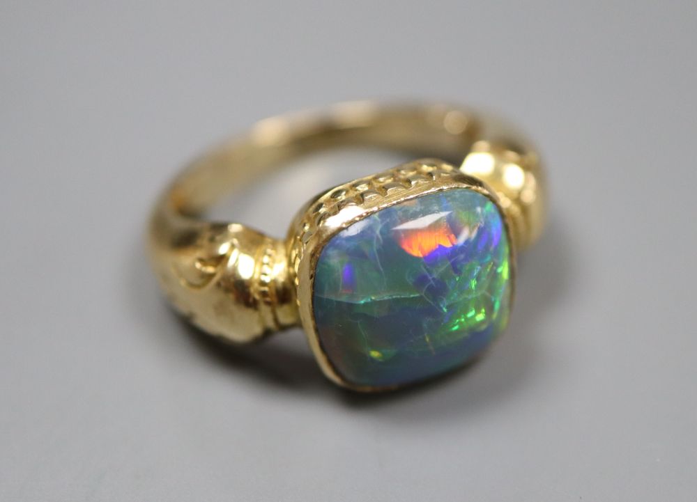 A yellow metal and opal set dress ring, size I, gross 7.4 grams.